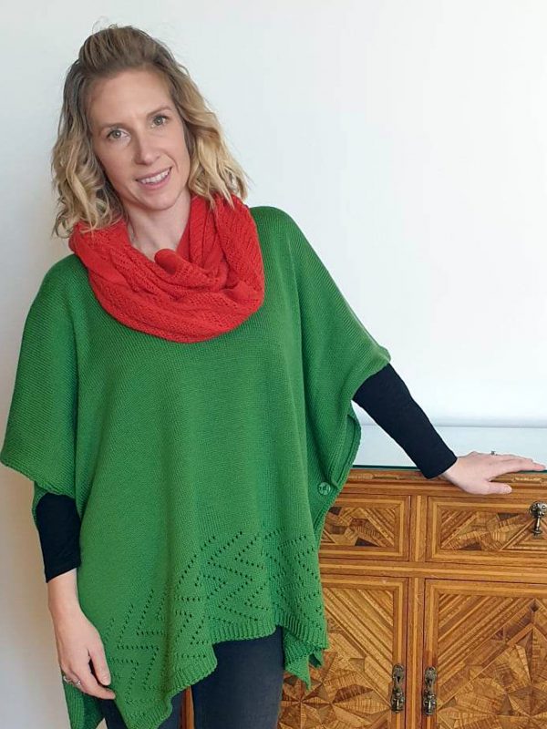 A lady standing indoors wearing a Coral Branberry Wool Infinity Scarf