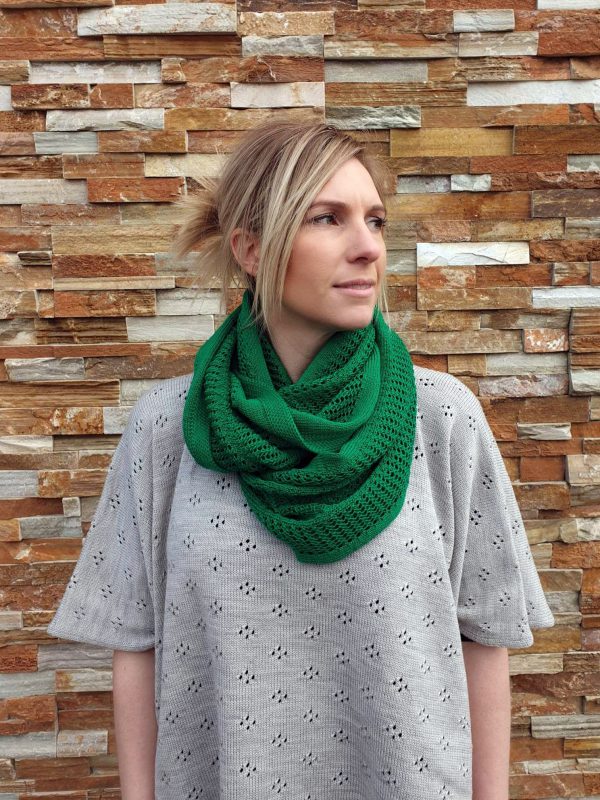 A lady standing outdoors wearing an Emerald Green Branberry Wool Infinity Scarf