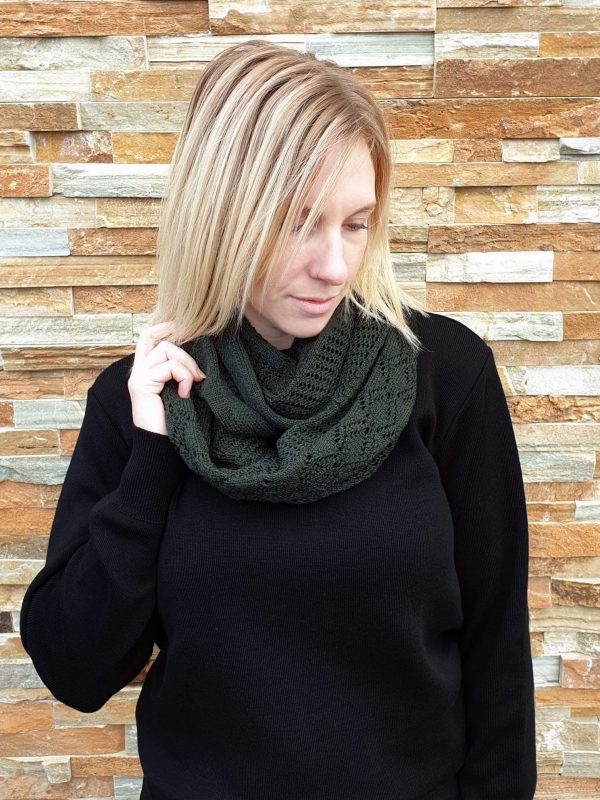 A lady standing outdoors wearing a Dark Forest Green Branberry Wool Infinity Scarf