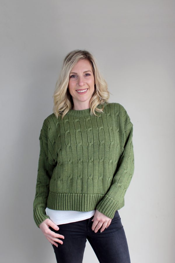 A lady wearing an Australian Made, Branberry merino wool cable crop, crew neck jumper in Olive Green