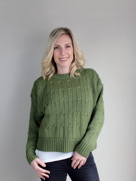 A lady wearing an Australian Made, Branberry merino wool cable crop, crew neck jumper in Olive Green