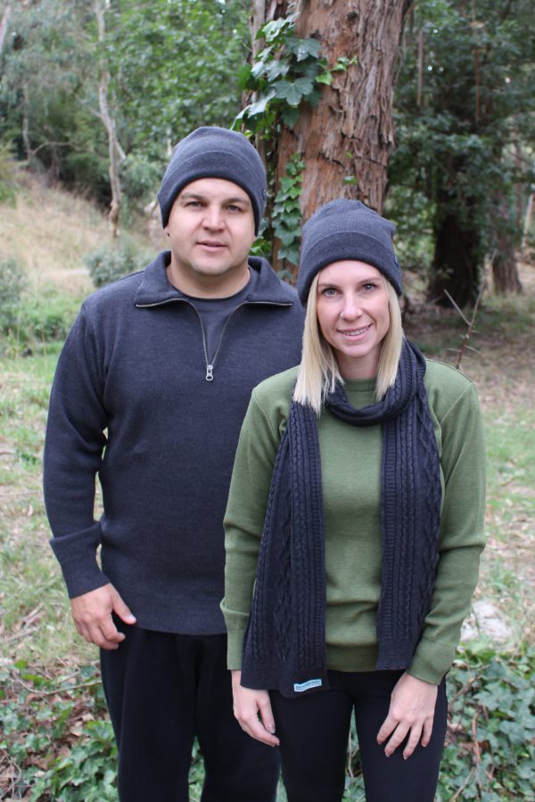A lady and man stading outside in the bush wearing Interknit Branberry branded Australian made pure merino wool beanies