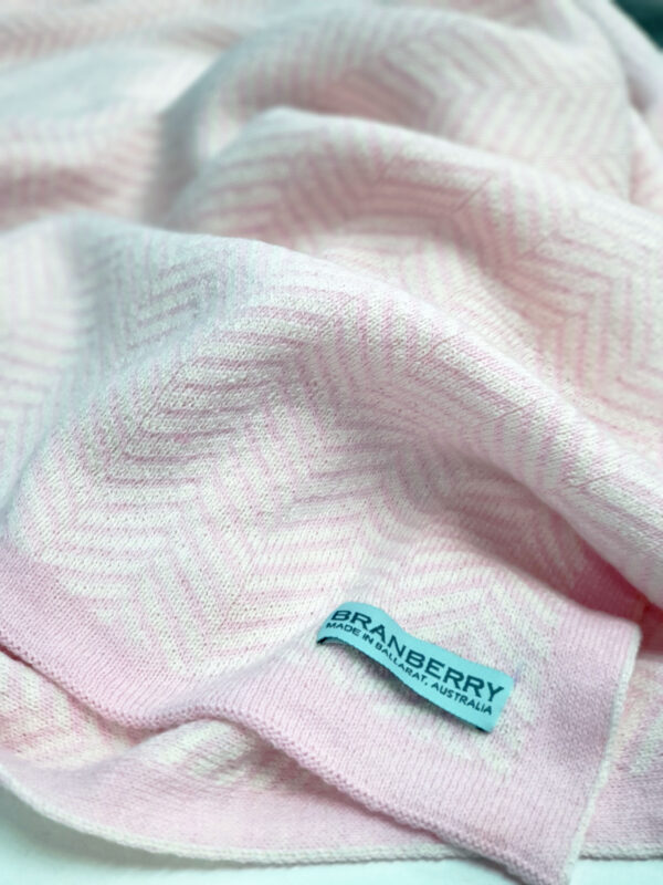 Close-up of Pastel Pink and White Herringbone Blanket with Branberry Label
