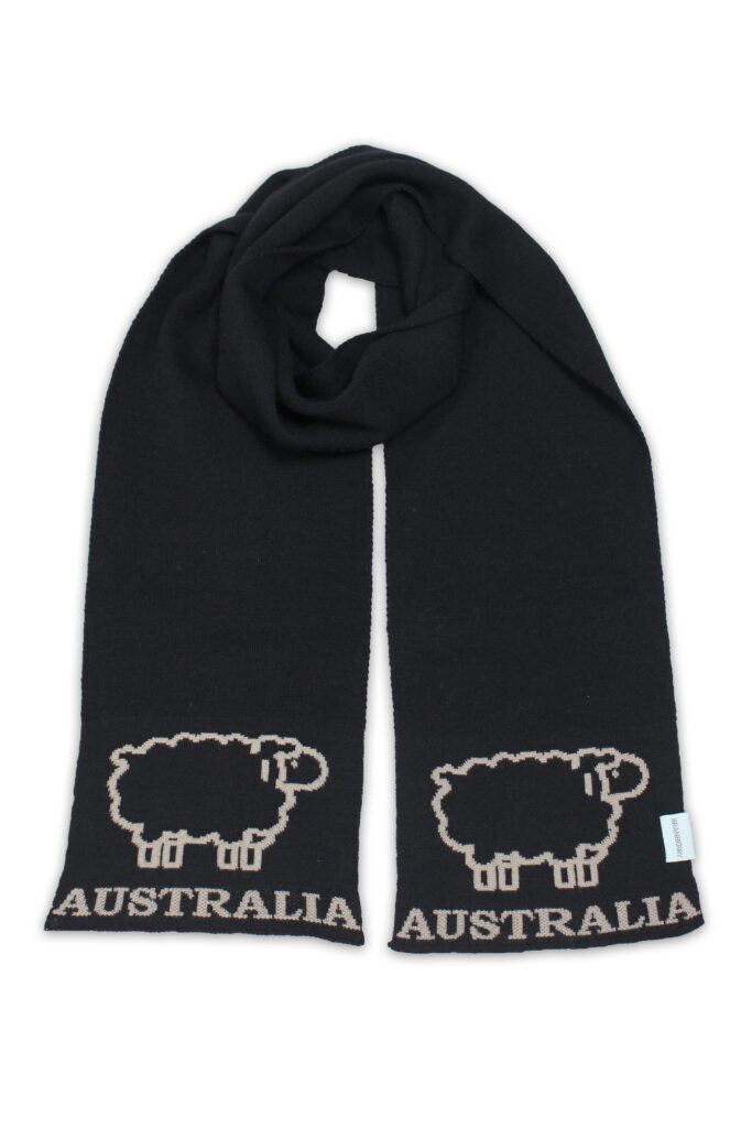Black Australian Merino Wool Sheep Scarf flat lay, showing beige sheep and 'Australia' on both ends