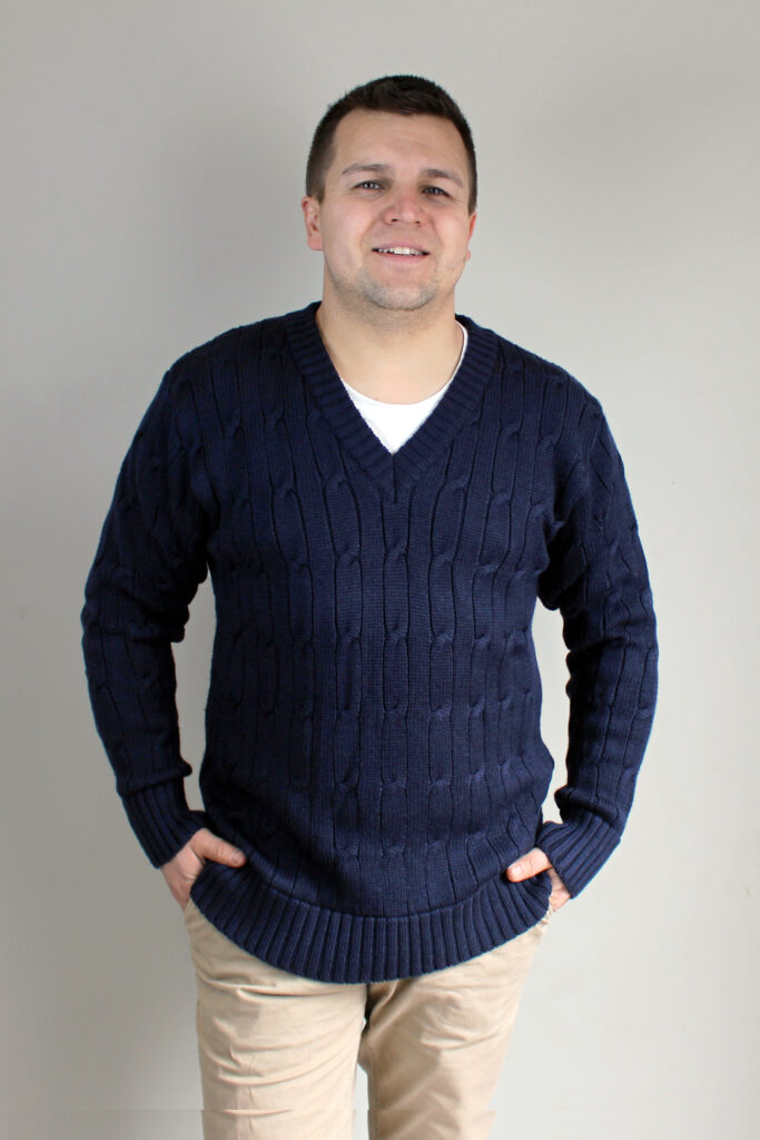 Smiling man wearing Connor Chunky Cable Knitted V-Neck Jumper in Navy