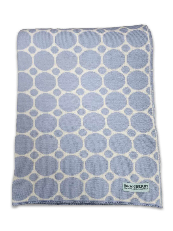 Flaylay product photo of an Australian Made, Australian Merino Wool Cot blanket. Its a dot and spot design in light blue and white colours.