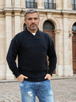 Man wearing a black Australian made Merino wool shawl neck jumper in moss stitch texture.